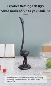 Close-up of vintage cast iron flamingo paper towel holder with textured metal finish
