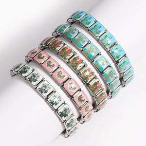 Detailed macro view of five Italian charm bracelets featuring floral enamel patterns on steel