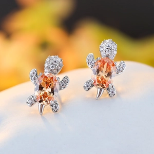 Silver sea turtle stud earrings with orange oval gemstone and sparkling zircon accents