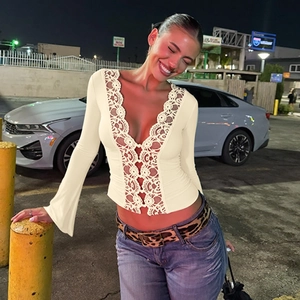 Close-up of beige lace V-neck top with button details and long sleeves for women