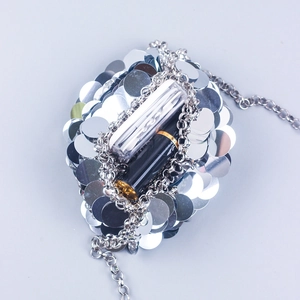 Detail view of silver sequin bag interior with metal chain strap and storage space