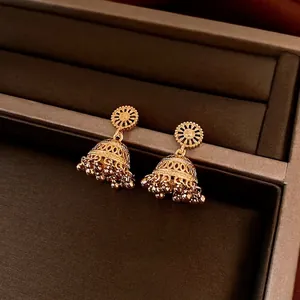 Retro 14K gold plated bell tassel earrings with intricate hollow design on jewelry box
