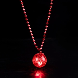 Detail of red beaded necklace featuring a glowing LED disco ball pendant on black background