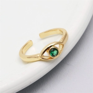 Detail of adjustable golden evil eye ring with micro-set green zircon gemstone