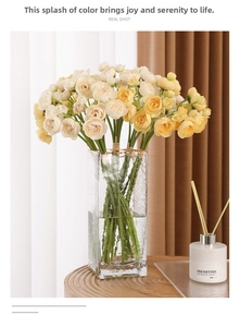 Close-up of artificial tea rose bouquet in cream and yellow with a ribbed glass vase