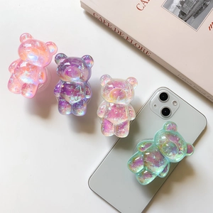 Close-up of four laser gradient bear phone grips with iridescent glitter filling