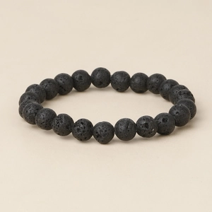 Macro detail of natural black lava stone beads showing porous volcanic texture