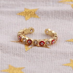 Close-up of gold Evil Eye ring with colorful enamel inlay and sparkling zircon stones