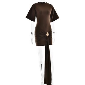 Detail of dark brown mini dress with golden shell buckle and elegant long ribbon sash