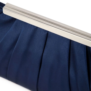 Close-up of pleated dark blue satin evening bag with a shiny silver metal frame clasp