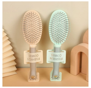 Detail view of beige and light green cushion hairbrushes with matching fashion stands