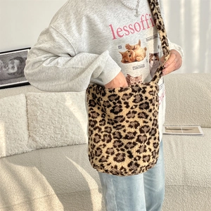 Close-up of leopard print plush bucket bag styled with a casual autumn outfit
