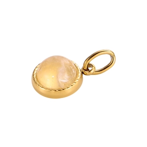 Close-up of a round gold-tone pendant featuring a translucent yellow gemstone inlay