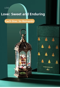 Detail of vintage Christmas snow globe lantern with Santa and luxury gift box