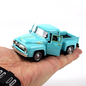 Close-up of light blue vintage alloy pickup truck model with openable side doors