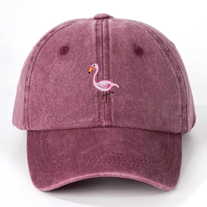 Detailed close-up of flamingo embroidery on a burgundy washed cotton baseball cap