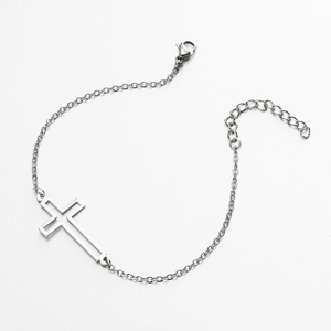 Minimalist stainless steel bracelet featuring a cutout cross pendant and adjustable chain