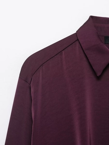 Detail of beaded collar and smooth poplin fabric on this dark purple long sleeve shirt