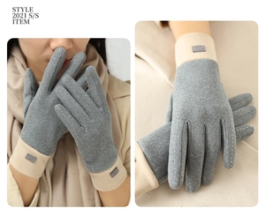 Detail of warm winter gloves with textured fleece fabric and fashion label stitching
