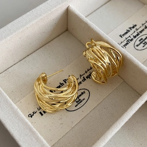 Golden multi-layer wire-wrapped C-shaped hoop earrings with pearls in a jewelry box