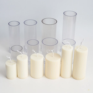 Detailed view of various sizes of transparent ribbed acrylic molds for candle making