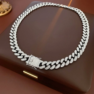 Detail shot of silver Cuban link necklace with iced out diamond square buckle closure
