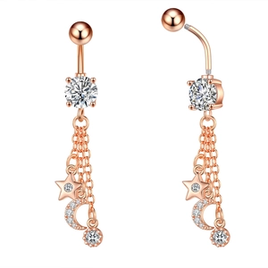 Rose gold belly piercing featuring large zircon stone and hanging star moon tassels