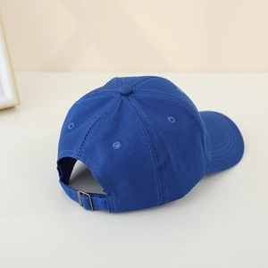 Detail of adjustable metal buckle strap on a navy blue cotton off-road car baseball cap