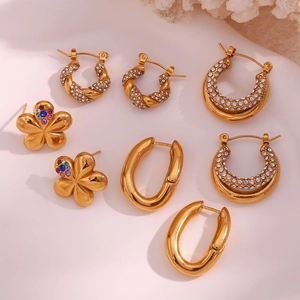 Detailed view of four pairs of vintage 18K gold plated earrings with micro-inlaid crystals