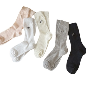 Five pairs of mesh socks with embroidered bows in pink, white, beige, grey, and black