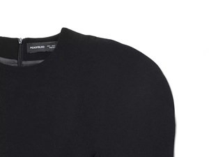 Close-up of the black dress neckline with metal zipper and fine textured fabric detail