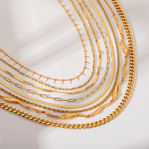 Close-up of golden stainless steel chains including Cuban, snake, and rope chain styles
