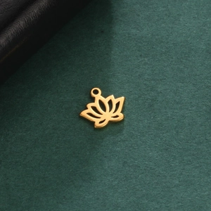 Detailed close-up of golden stainless steel lotus flower pendant on a dark texture
