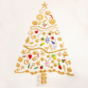 Creative Christmas tree arrangement of 18k gold plated jewelry charms and bracelets