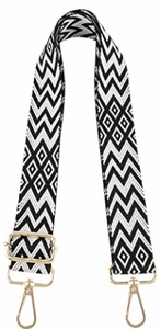 Detail of adjustable black and white zigzag woven bag strap with gold metal hooks