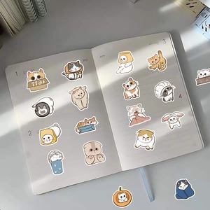 Detail shot of cute cartoon cat stickers applied on a lined notebook for decoration