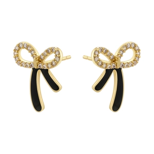 Detail of gold bow earrings with black enamel and white crystal center inlay