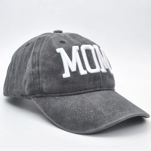 Detail of 3D embroidery showing White MOM text on washed dark grey cotton baseball cap