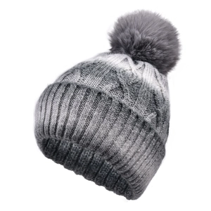 Close-up of grey gradient knit beanie showing thick cable stitch and fluffy faux fur pompom