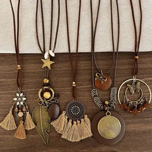 Macro shot of 5-piece bohemian pendant necklace set with bronze charms and tassels