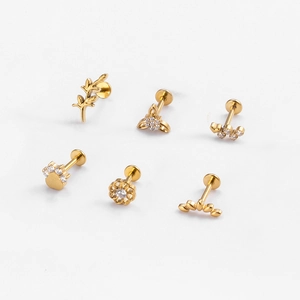 Collection of golden G23 titanium stud earrings with leaf and flower zircon designs