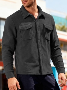 Detail of men's fleece tactical jacket showing heavy fabric texture and chest pockets