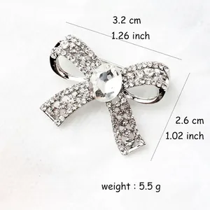 Elegant bow brooch with sparkling rhinestones and center oval stone, 3.2cm wide design