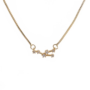 Detailed close-up of golden zodiac pendant necklace with sparkling cubic zirconia inlay