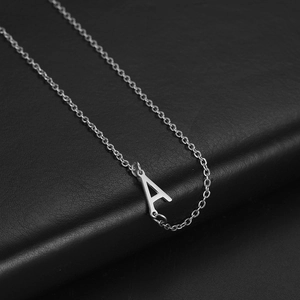 Minimalist silver stainless steel 304 necklace with letter A pendant on black leather background