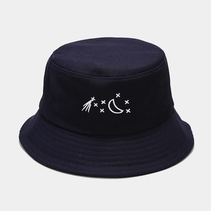 Detail of star and moon embroidery on navy cotton bucket hat with stitched brim
