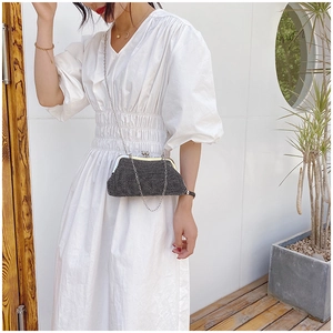 Detail of elegant black rhinestone clutch bag with silver chain strap for evening events
