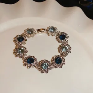 Vintage floral bracelet with blue crystals and sparkling rhinestones on white plate