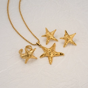18k gold plated starfish necklace earrings and ring jewelry set on white fabric