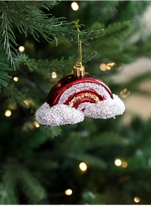 Close-up of burgundy rainbow-shaped Christmas ornament with white glitter on a tree